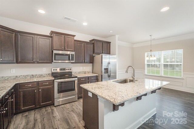 159 Rubys Way Unit 35, Oakboro, NC 28129 - kitchen with appliances with stainless steel finishes, a sink, dark wood-style flooring, dark brown cabinetry, and a wainscoted wall