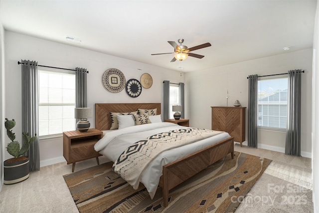 159 Rubys Way Unit 35, Oakboro, NC 28129 - bedroom featuring baseboards, multiple windows, a ceiling fan, and light carpet
