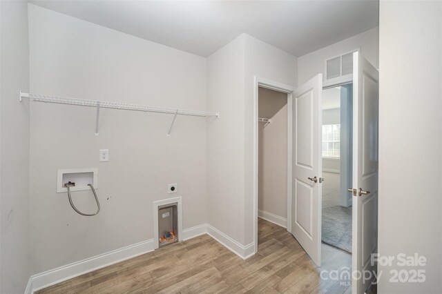 159 Rubys Way Unit 35, Oakboro, NC 28129 - laundry area featuring washer hookup, hookup for an electric dryer, light wood finished floors, and baseboards
