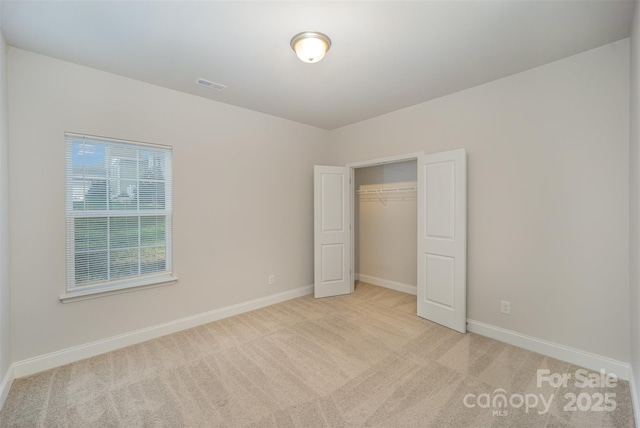 159 Rubys Way Unit 35, Oakboro, NC 28129 - unfurnished bedroom with light colored carpet, baseboards, and a closet