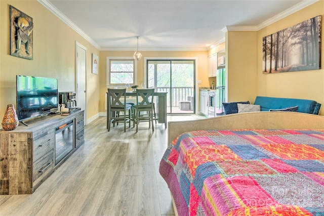 bedroom featuring access to exterior, white refrigerator, light hardwood / wood-style flooring, and crown molding