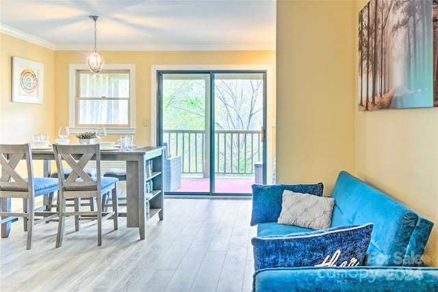 dining space with hardwood / wood-style floors and ornamental molding