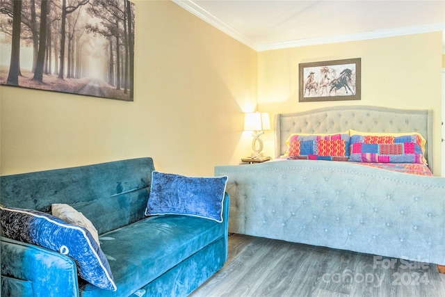 bedroom with wood-type flooring and ornamental molding