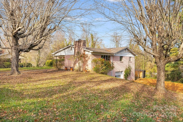 view of side of home featuring a lawn