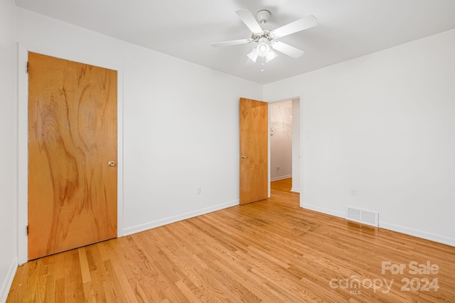 unfurnished room with ceiling fan and light wood-type flooring