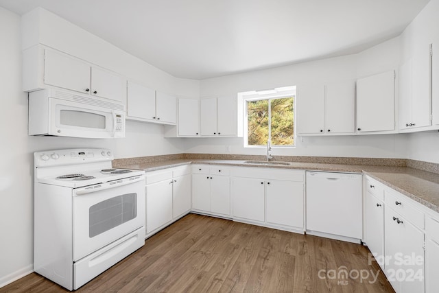 kitchen with hardwood / wood-style floors, white cabinets, white appliances, and sink