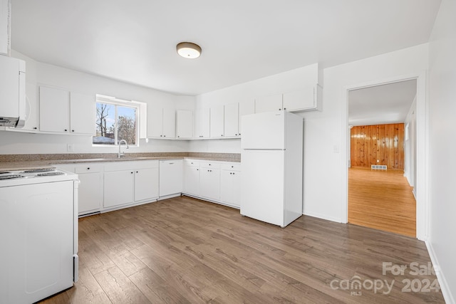 kitchen with white cabinets, sink, white appliances, and hardwood / wood-style floors