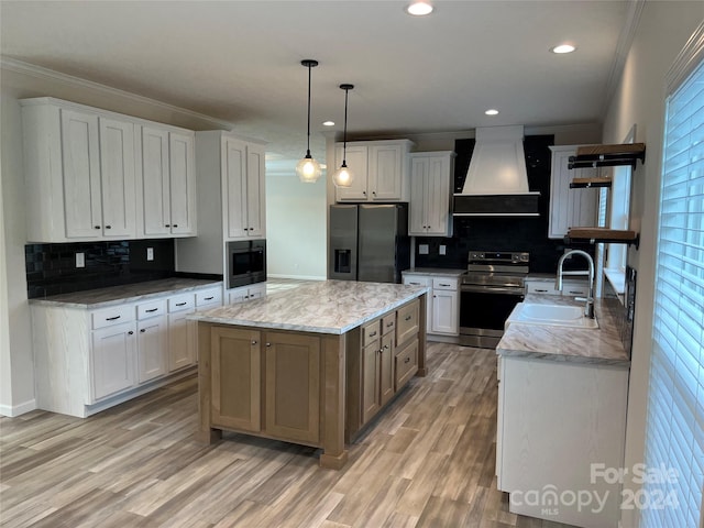 kitchen with custom range hood, stainless steel appliances, a kitchen island, sink, and white cabinetry