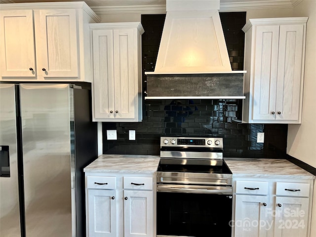 kitchen with tasteful backsplash, white cabinets, stainless steel appliances, and custom range hood