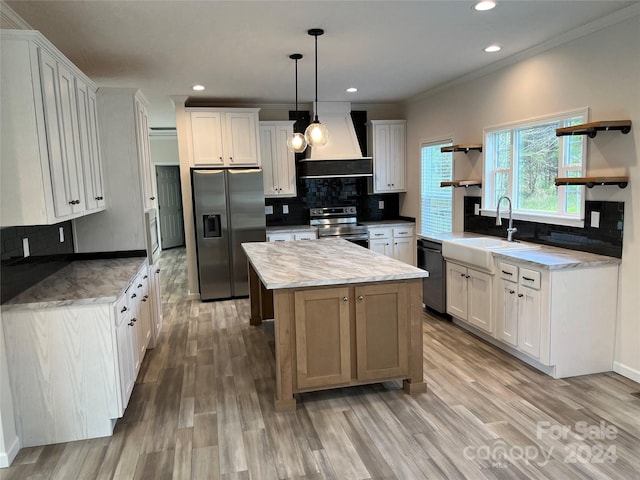 kitchen with appliances with stainless steel finishes, white cabinetry, pendant lighting, and custom exhaust hood