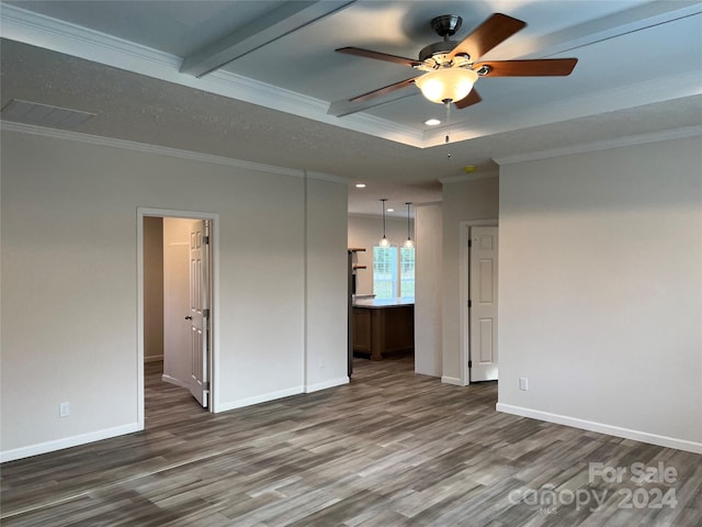 spare room with beam ceiling, hardwood / wood-style flooring, ceiling fan, and crown molding