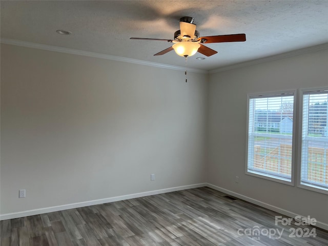 empty room featuring hardwood / wood-style floors, a textured ceiling, ceiling fan, and ornamental molding