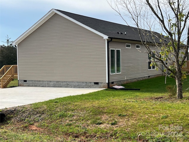 view of property exterior featuring a patio and a lawn