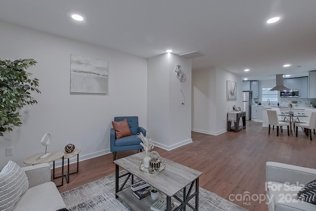 living room featuring light hardwood / wood-style flooring and sink