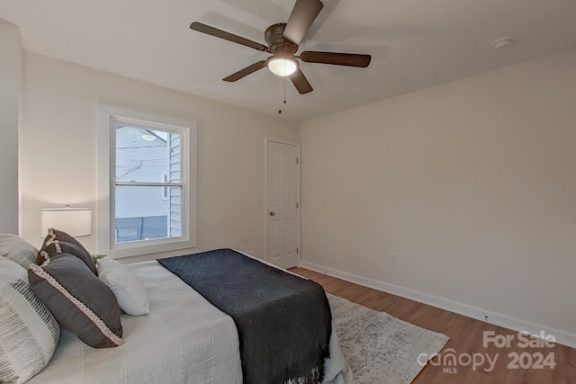 bedroom with hardwood / wood-style flooring and ceiling fan