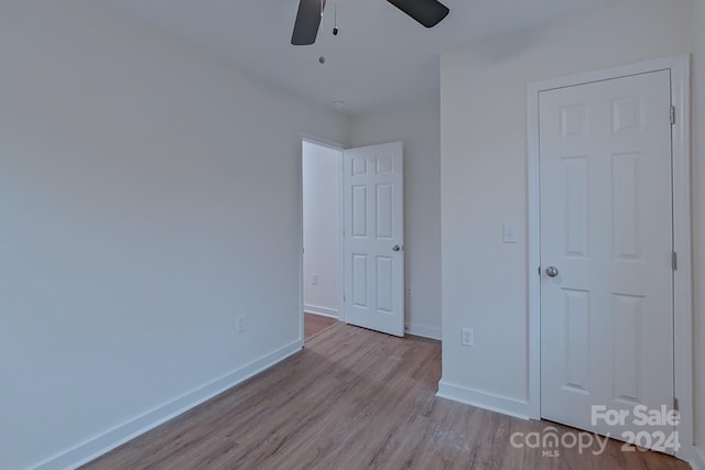 unfurnished bedroom featuring ceiling fan and light hardwood / wood-style floors