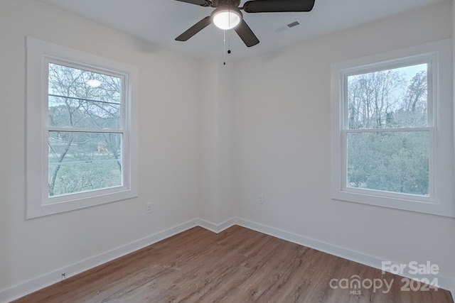 spare room with ceiling fan and hardwood / wood-style floors