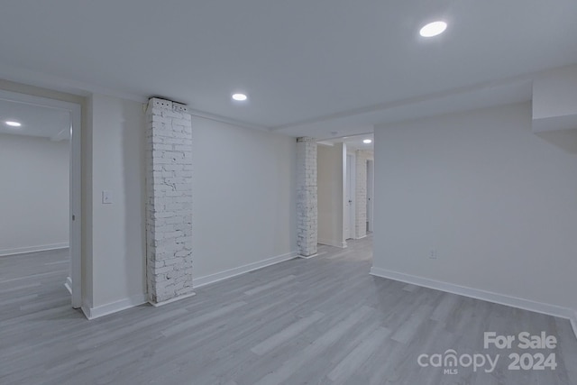 basement with light hardwood / wood-style floors