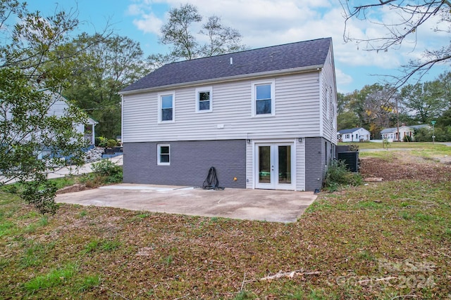 rear view of house with a yard and a patio