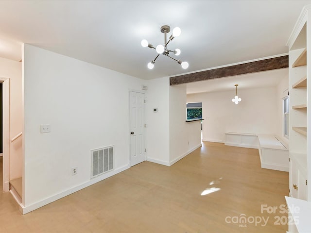 unfurnished living room with a chandelier and light hardwood / wood-style flooring