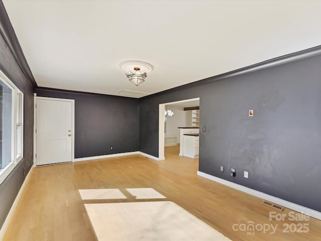 unfurnished room featuring crown molding and hardwood / wood-style flooring