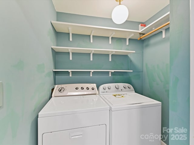 washroom featuring washer and clothes dryer