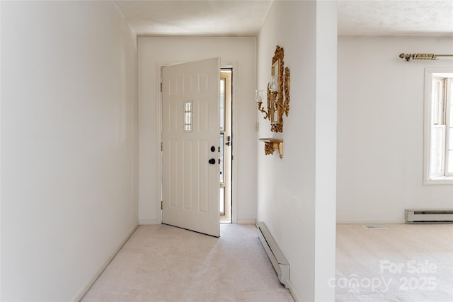 261 Lower Christ School Rd, Fletcher, NC 28732 - entrance foyer with baseboard heating, light colored carpet, and baseboards