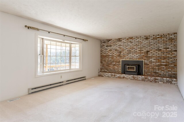 261 Lower Christ School Rd, Fletcher, NC 28732 - unfurnished living room with a baseboard heating unit, carpet floors, a wood stove, and a textured ceiling