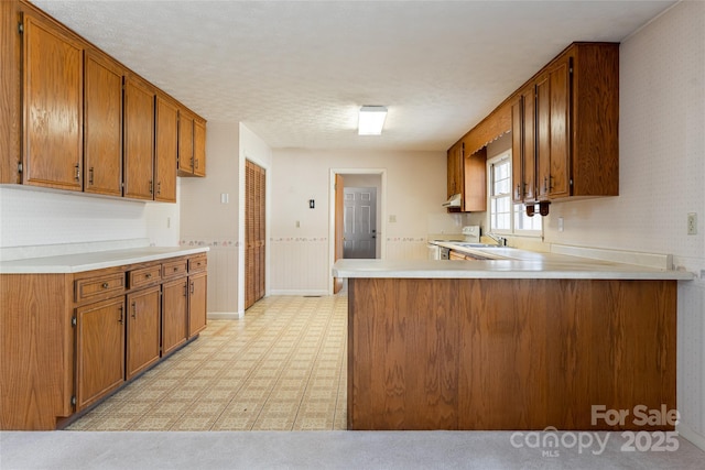 261 Lower Christ School Rd, Fletcher, NC 28732 - kitchen with white electric range oven, light countertops, a sink, and brown cabinets