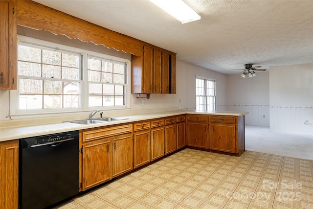261 Lower Christ School Rd, Fletcher, NC 28732 - kitchen featuring dishwasher, a sink, brown cabinets, a peninsula, and light countertops