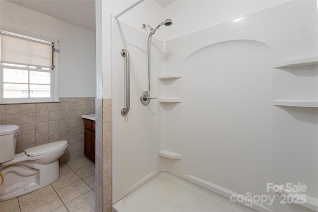 261 Lower Christ School Rd, Fletcher, NC 28732 - full bath with toilet, tile patterned floors, tile walls, a stall shower, and a wainscoted wall