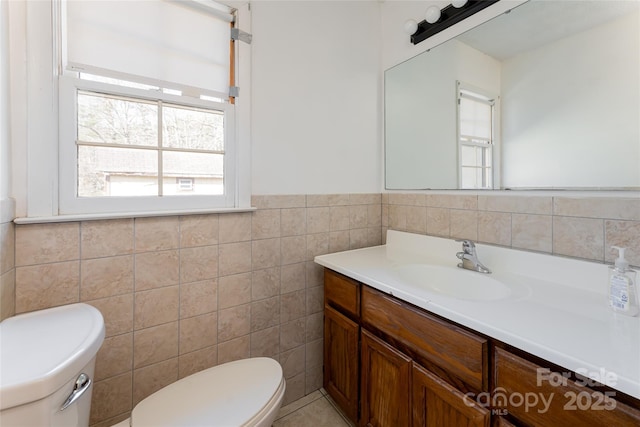 261 Lower Christ School Rd, Fletcher, NC 28732 - half bathroom with toilet, vanity, tile walls, and a wainscoted wall