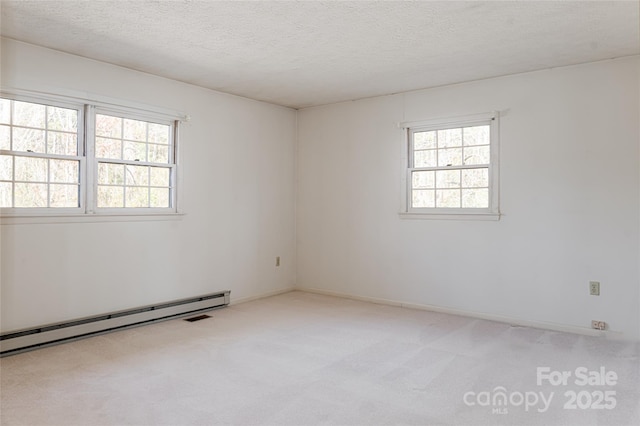 261 Lower Christ School Rd, Fletcher, NC 28732 - spare room with a baseboard heating unit, carpet flooring, healthy amount of natural light, and a textured ceiling