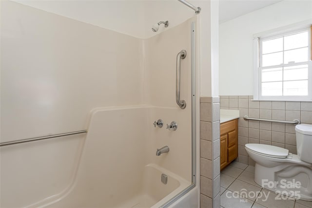 261 Lower Christ School Rd, Fletcher, NC 28732 - full bathroom featuring tile walls, tile patterned floors, toilet, vanity, and a wainscoted wall