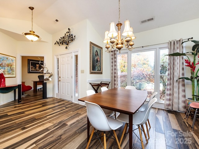 dining room with dark hardwood / wood-style flooring, a notable chandelier, and lofted ceiling