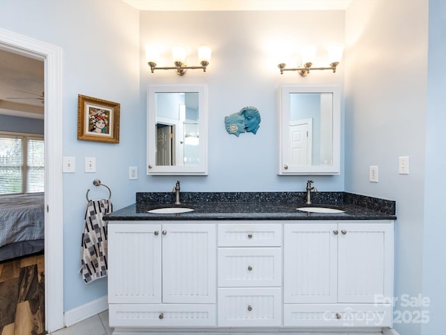 bathroom with ceiling fan and vanity