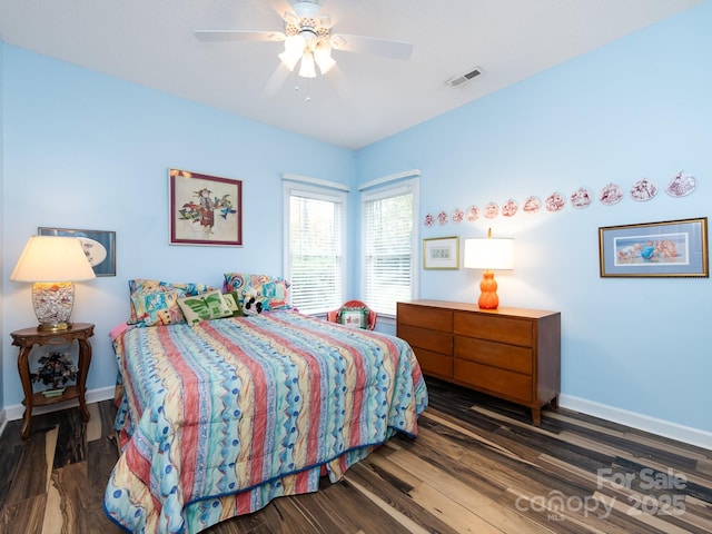 bedroom with ceiling fan and dark hardwood / wood-style flooring