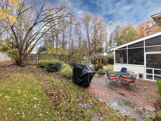 view of yard featuring a patio area and a sunroom