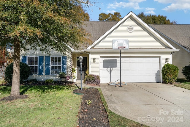 view of front of property featuring a garage and a front lawn