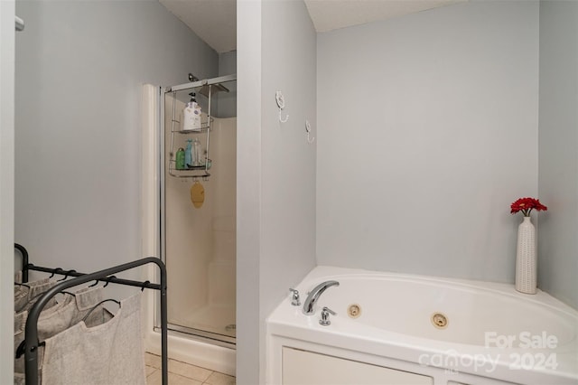 bathroom featuring tile patterned flooring and separate shower and tub