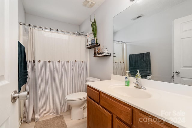 bathroom featuring tile patterned flooring, vanity, and toilet