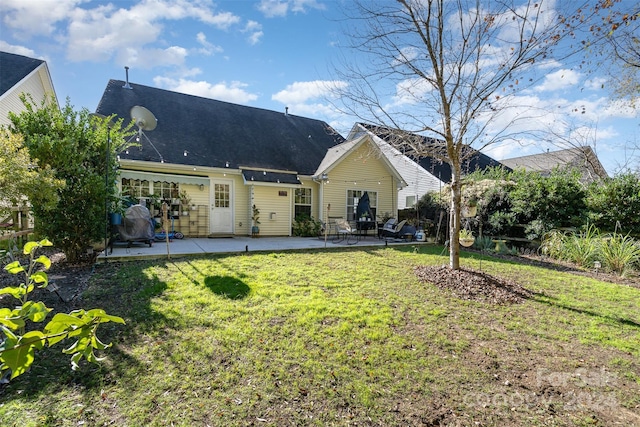 rear view of house with a yard and a patio area