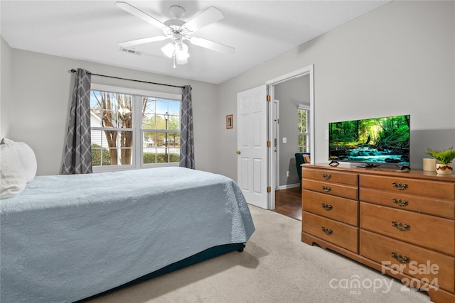 carpeted bedroom with ceiling fan