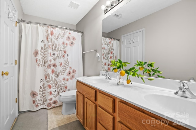 bathroom with tile patterned floors, vanity, toilet, and a shower with curtain