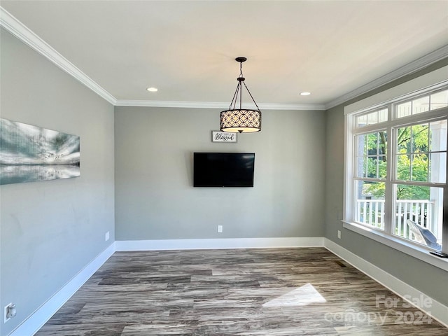 unfurnished dining area featuring crown molding and dark hardwood / wood-style floors