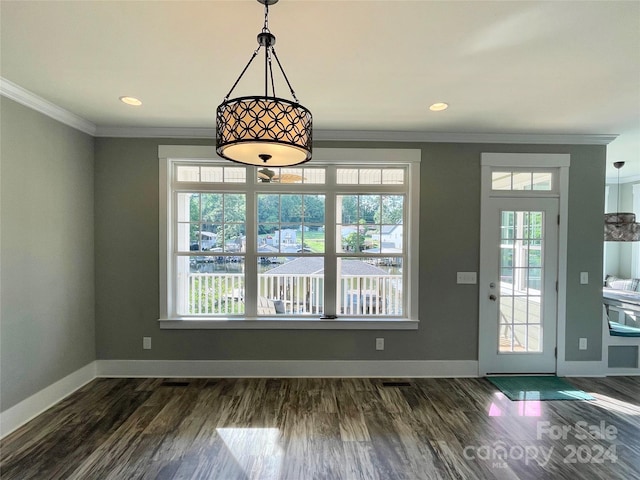 unfurnished dining area with ornamental molding and dark wood-type flooring