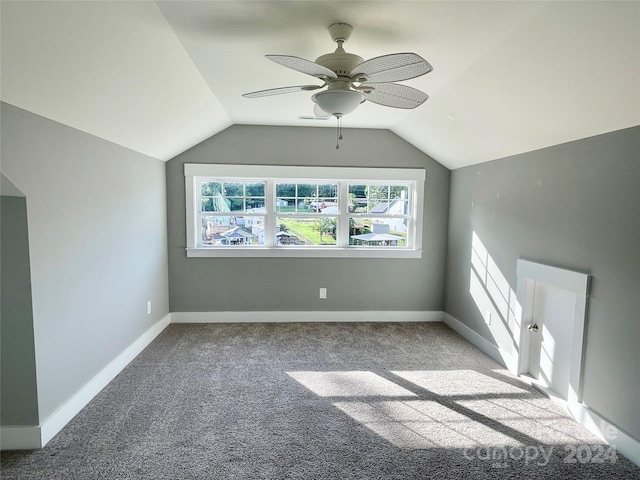 additional living space featuring light colored carpet, ceiling fan, and lofted ceiling