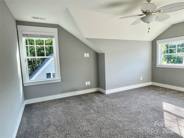 bonus room featuring ceiling fan, dark carpet, and lofted ceiling