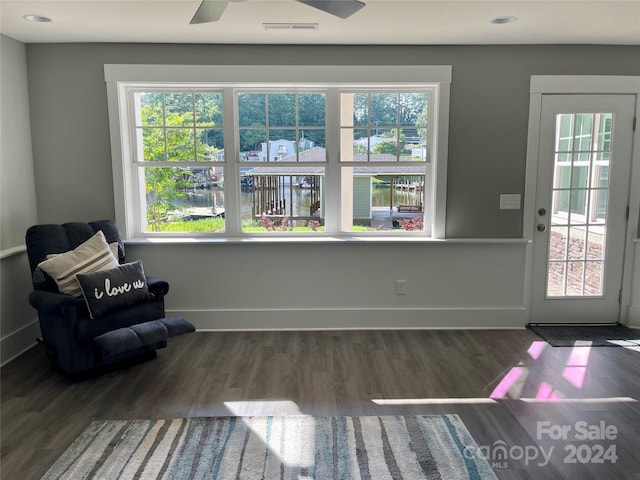 sitting room featuring plenty of natural light, ceiling fan, and dark hardwood / wood-style flooring