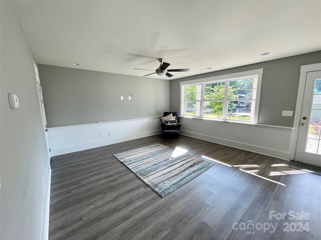 spare room with ceiling fan and dark wood-type flooring